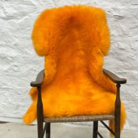 Sheepskin Rug British Luxe Orange by Owen Barry on Chair